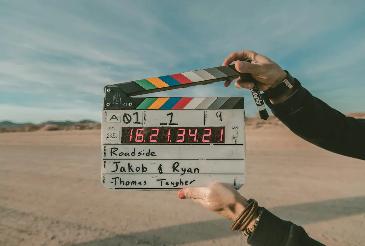A film clapperboard held by a crew member on location