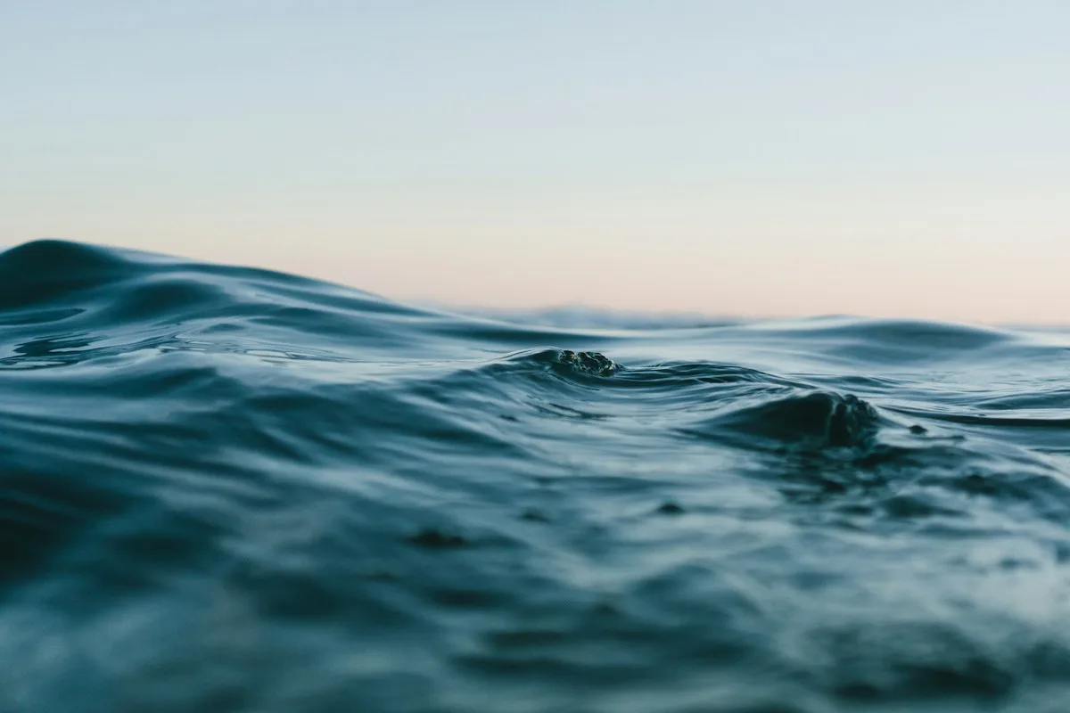 Blue ocean waves in delicate evening light